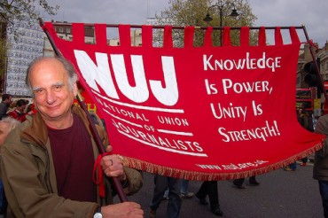Branch member Larry Herman with our banner on the Mayday trade union rally in London: ©</A> <B>Marc Vallée