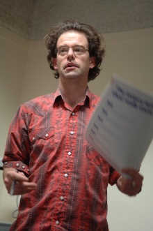 Andrew Mueller waves a piece of paper; Photo ©: Guy Smallman