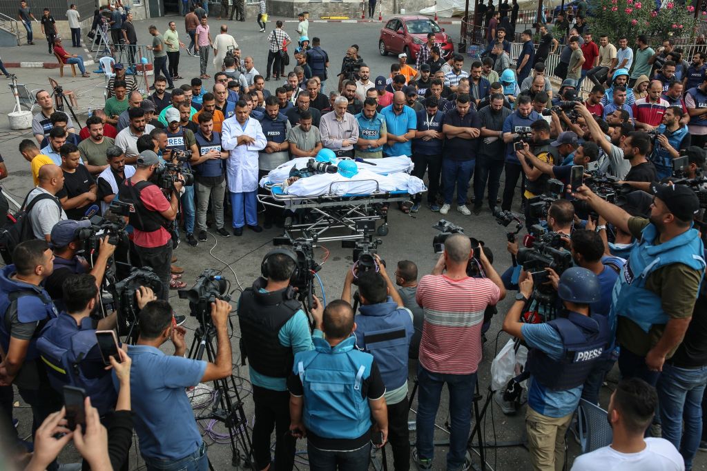 Mourners around a sttetcher