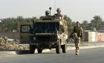 British soldiers from the Duke Of Wellingtons Regiment provide a security cordon for other British troops searching a route in © Paul David Drabble