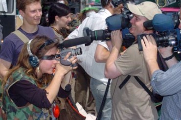 Avideographer embedded with the Clown Army
films unembedded reporters filming... © 2005 Guido