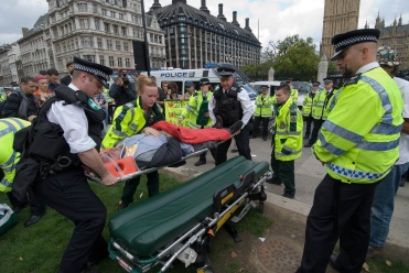 Marc Vallée is loaded into an ambulance, with the assistance of police medics