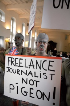 Freelance journalists protest in Brussels dressed as pigoens