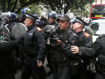 Police photographer with riot police; Matt Salusbury