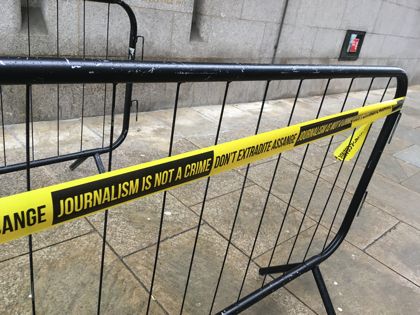 Crash barrier decorated with Assange tape