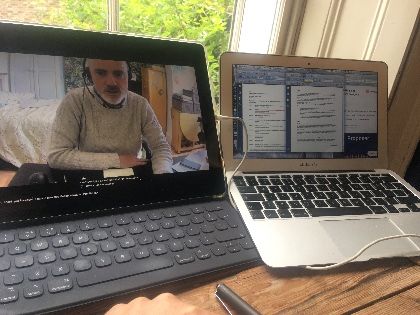 Two laptops with various websites open